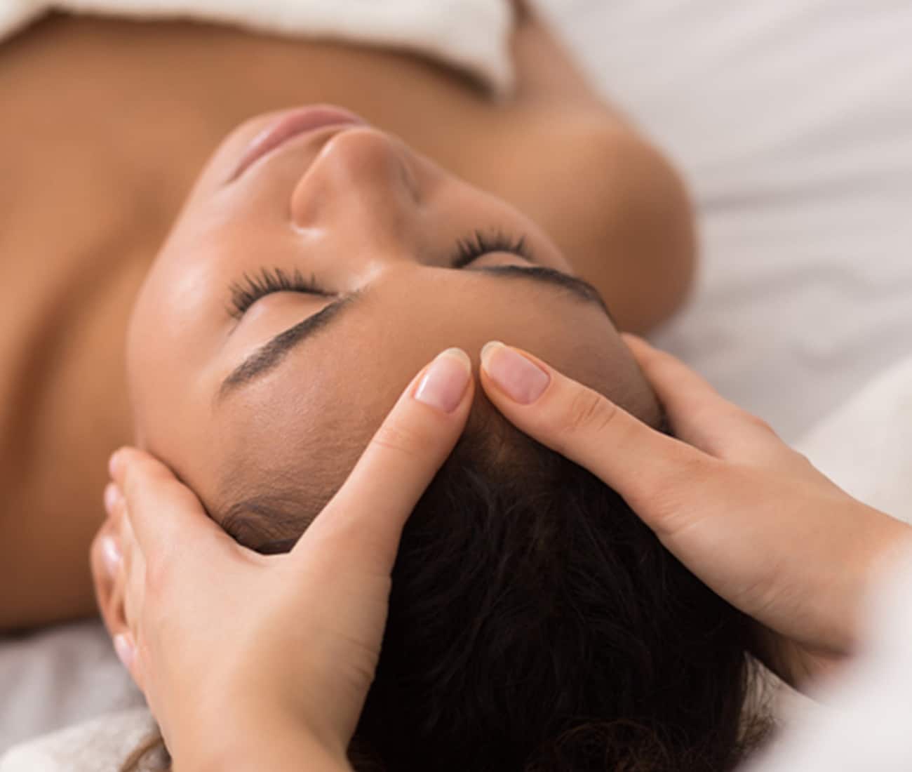 A woman getting her head massaged