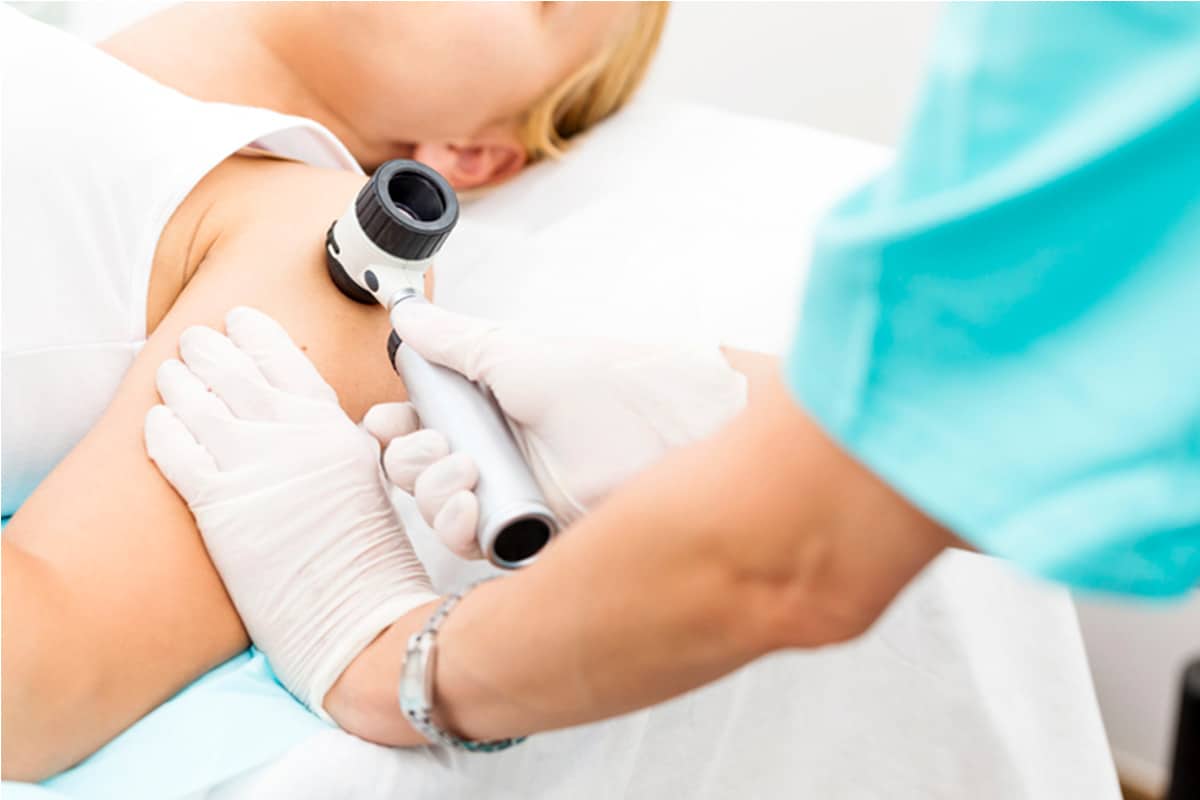 Doctor checking patients skin