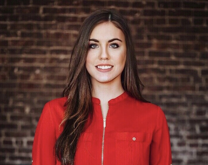 a person standing in front of a brick building